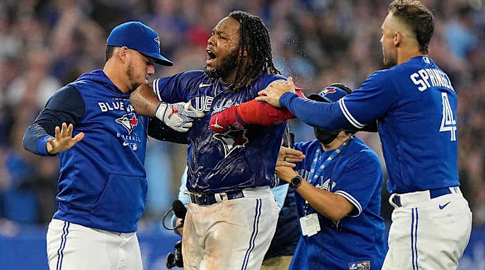 Sep 26, 2022; Toronto, Ontario, CAN; Toronto Blue Jays first baseman Vladimir Guerrero Jr. (center) celebrates after hitting a walk-off single against the New York Yankees during the tenth inning at Rogers Centre.