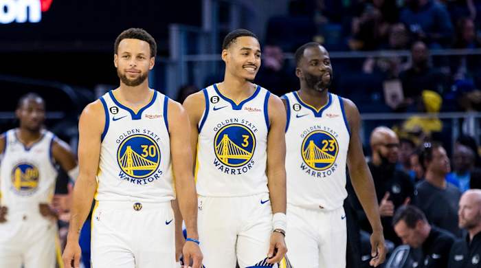 Oct 14, 2022; San Francisco, California, USA; Golden State Warriors guard Jordan Poole (3) and guard Stephen Curry (30) and forward Draymond Green (23) re-enter the court after a time-out during the first half of the game against the Denver Nuggets at Chase Center.