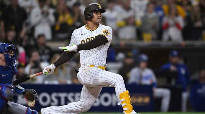 Oct 15, 2022; San Diego, California, USA; San Diego Padres right fielder Juan Soto (22) hits an RBI-single in the seventh inn against the Los Angeles Dodgers during game four of the NLDS for the 2022 MLB Playoffs at Petco Park.