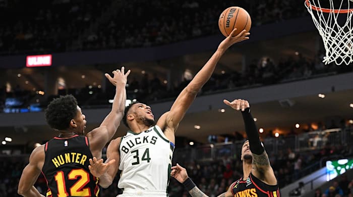Nov 14, 2022; Milwaukee, Wisconsin, USA; Milwaukee Bucks forward Giannis Antetokounmpo (34) drives to the basket against Atlanta Hawks forward De’Andre Hunter (12) and forward John Collins (20) in the second quarter at Fiserv Forum.