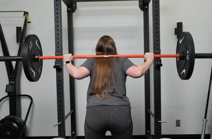 Woman using Nike Coated Barbell