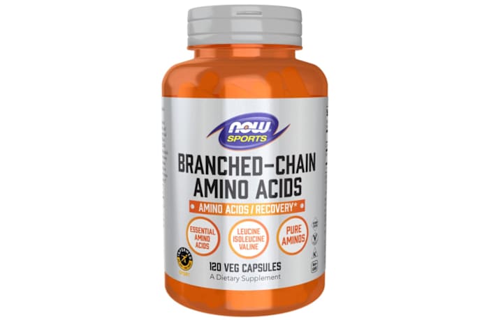 An orange and silver bottle of NOW Sports BCAA capsules against a white background
