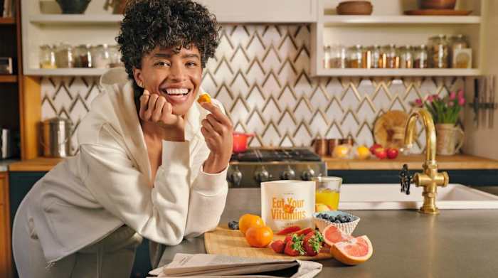 A woman holding her daily GEM multivitamin