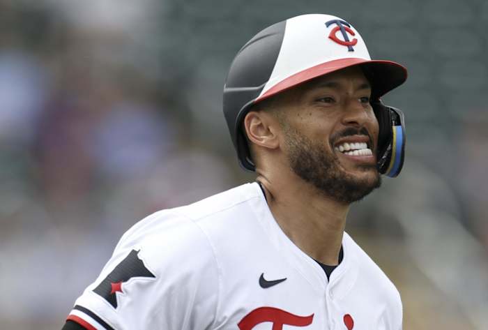 Mar 6, 2024; Fort Myers, Florida, USA; Minnesota Twins shortstop Carlos Correa (4) tries to run out a ground ball against the Boston Red Sox in the fifth inning at Hammond Stadium.