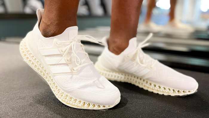 Adidas Ultra 4DFWD shoes in cream on treadmill.