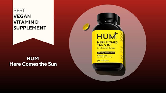 A red background with a white banner that says, "Best Vegan Vitamin D Supplement" next to a black and bright yellow container that says HUM Here Comes the Sun in black font