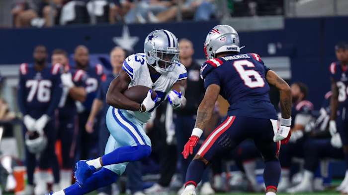 Oct 1, 2023; Arlington, Texas, USA; Dallas Cowboys wide receiver Michael Gallup (13) runs with the ball as New England Patriots cornerback Christian Gonzalez (6) defends during the first quarter at AT&T Stadium.
