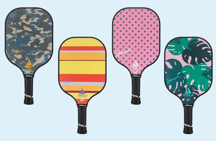 Four Joola Journey Pickleball Paddles with varying designs on the hitting surfaces that include green camouflage, stripes, polka dots, and plant leaves.