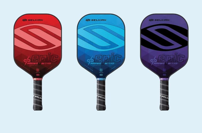 Three Selkirk AMPED 2021 Epic Lightweight Pickleball Paddles with black handles and a red, blue, and purple hitting surface.