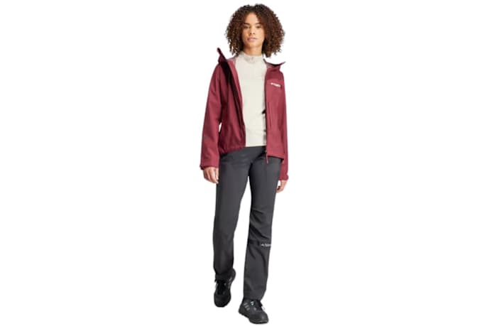 A woman wearing a red adidas Terrex rain jacket