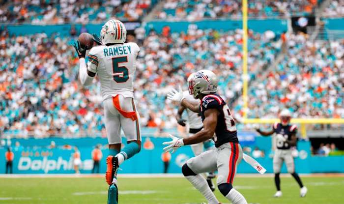 Miami Dolphins cornerback Jalen Ramsey (5) intercepts a pass intended to New England Patriots wide receiver Kendrick Bourne (84) during the second quarter at Hard Rock Stadium.