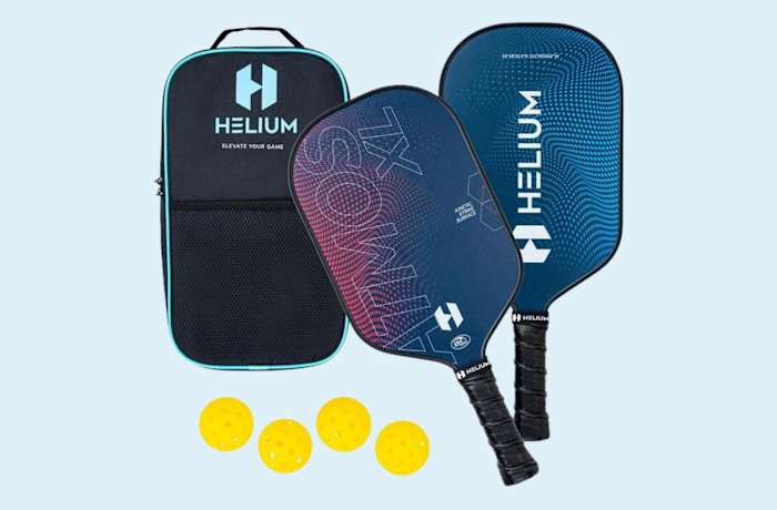 Two Helium Atmos pickleball paddles with black handles and red and blue hitting surfaces with a black carrying case and four yellow balls.