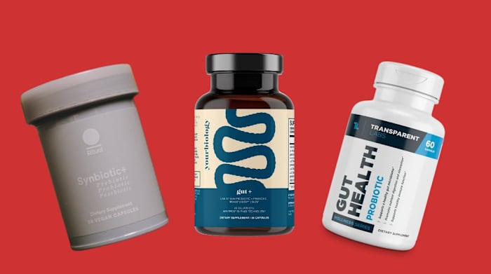 A red background featuring three bottles of probiotic supplements including Ritual Synbiotic+ probiotic and prebiotic, YourBiology gut+ and Transparent Labs gut health probiotic