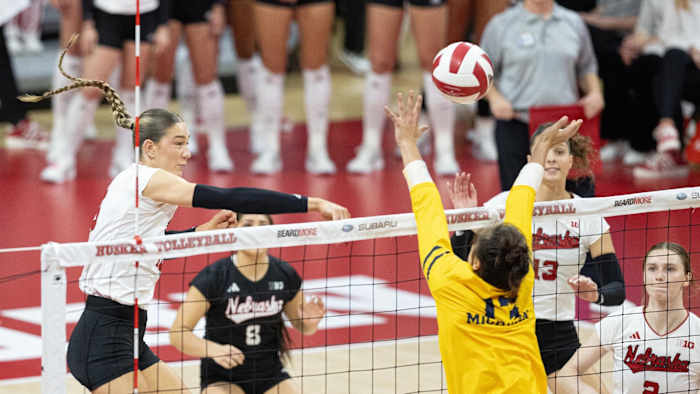 Nebraska middles Andi Jackson attacks a ball against Michigan (Nov. 17, 2023)