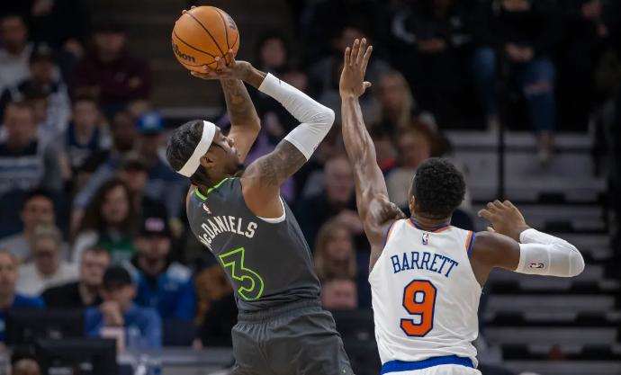 RJ Barrett guards Jaden McDaniels in Monday's loss in Minnesota