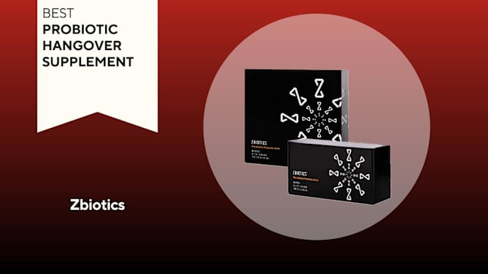 Two black boxes of the Zbiotics probiotic hangover supplement against a red background.