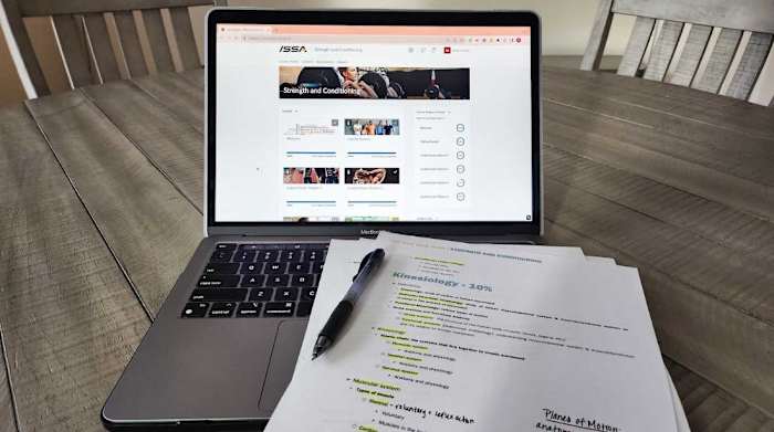 issa-strength-and-conditioning-course-content-laptop-on-table-notes-pen_hero