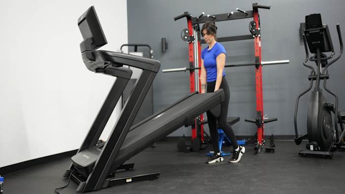 Woman lowering deck of NordicTrack 1750