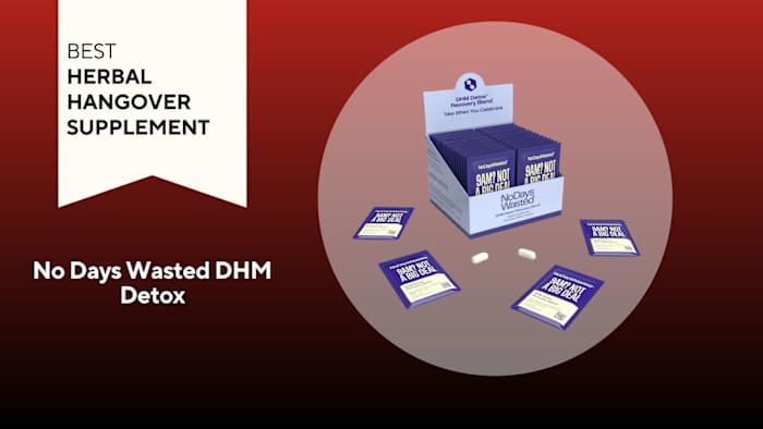 A light purple box filled with dark purple packets of No Days Wasted DHM Detox Recovery Blend with two pills outside the box and four packets of pills outside the box against a red background.