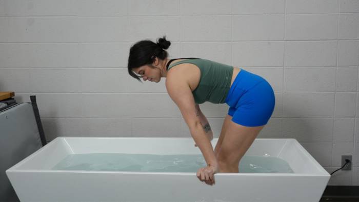 Woman getting into Plunge tub with water