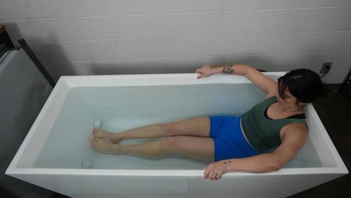 Woman sitting in Plunge Cold Plunge Tub