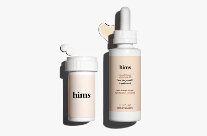 Two hims hair regrowth products, including one serum and one bottle of tablets, against a white background.