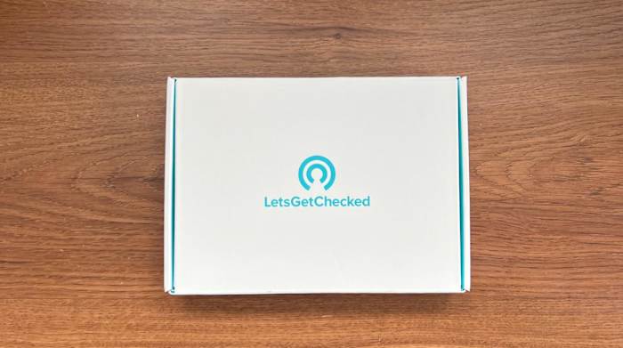 The boxed up LetsGetChecked Heart Health Test kit on a wooden surface