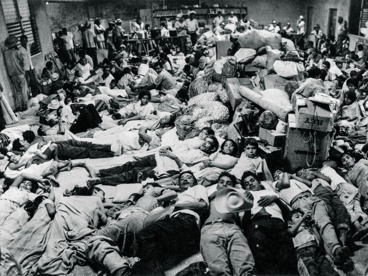 Salvadorian nationals who were residing in Honduras arrive at the Red Cross headquarters in San Miguel on July 7, 1969. Following the armed conflict between El Salvador and Honduras, 14,000 nationals residing in Honduras returned to their country.