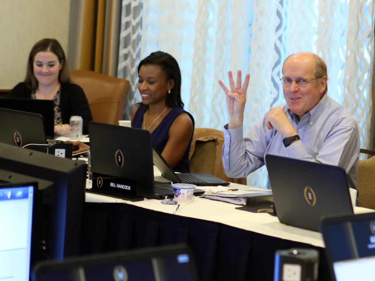 CFP executive director Bill Hancock sits next to Laila Brock during a committee meeting. In the background to the left is Gina Lehe’s corner desk. A replacement sits in her seat. She was delivering her second daughter at the time of this meeting.