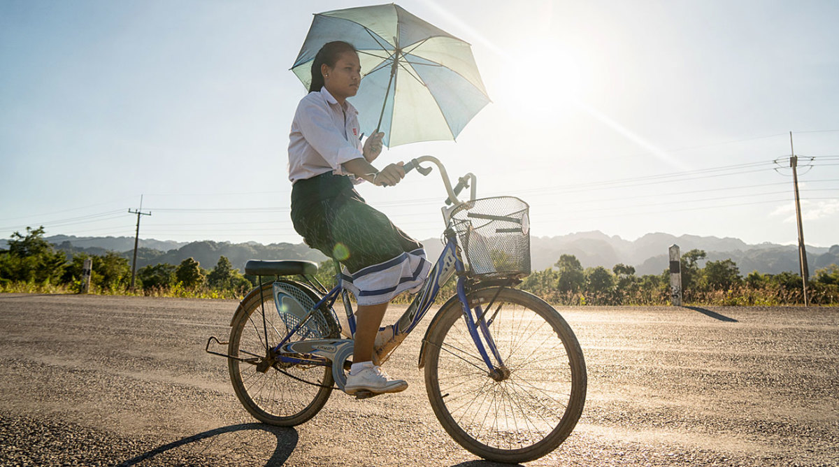 A schoolgirl cycling in Laos. 