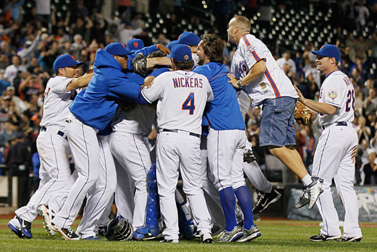 Santana's no-hitter led to a championship-worthy celebration, and even a fan (shorts, right) had to be a part of it.
