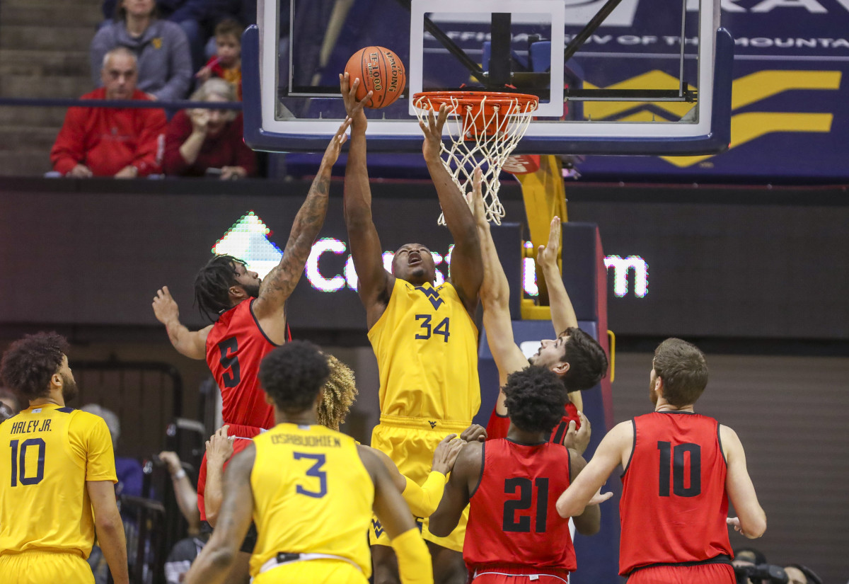 West Virginia Mountaineers forward Oscar Tshiebwe (34) shoots the ball over Austin Peay Governors guard Jordyn Adams (5) during the first half at WVU Coliseum.