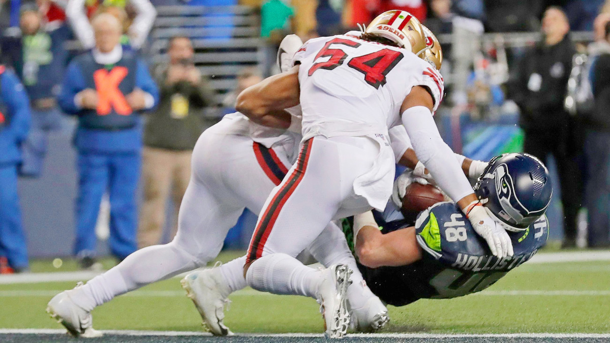 Greenlaw (left) and LB Fred Warner (54) stonewalled Hollister inside the one to preserve San Francisco’s win.