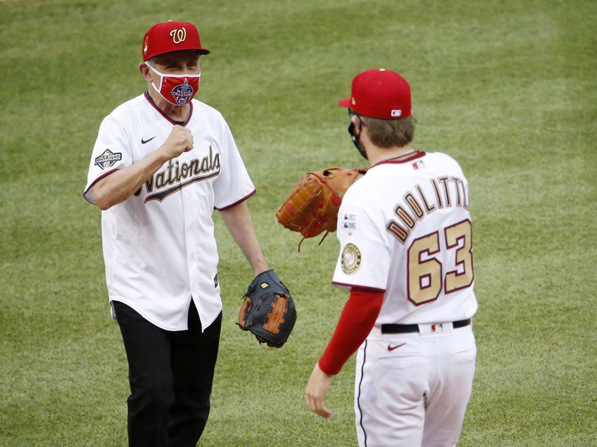 Jul 23, 2020; Washington, DC, USA; National Institute of of Allergy and Infectious Diseases director Dr. Anthony Fauci greets Washington Nationals relief pitcher Sean Doolittle (63) after throwing out the ceremonial first pitch before MLB Opening Day between the New York Yankees and the Washington Nationals at Nationals Park.
