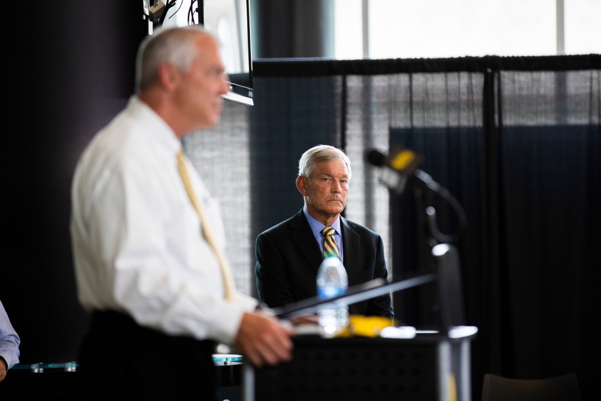 Iowa football coach Kirk Ferentz listens to athletic director Gary Barta speak during Thursday's press conference in Iowa City. (Katina Zentz/Iowa City Press-Citizen-Imagn Content Services)