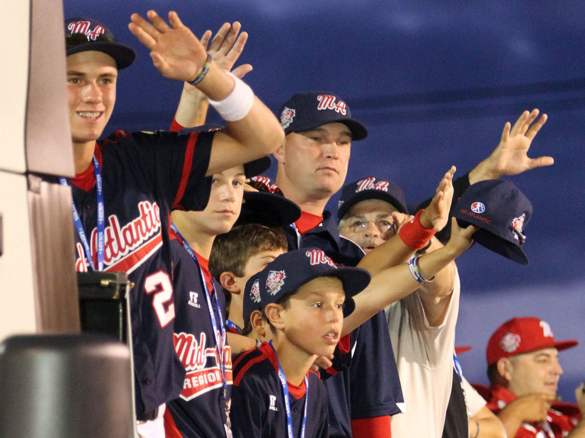 Little League players wave