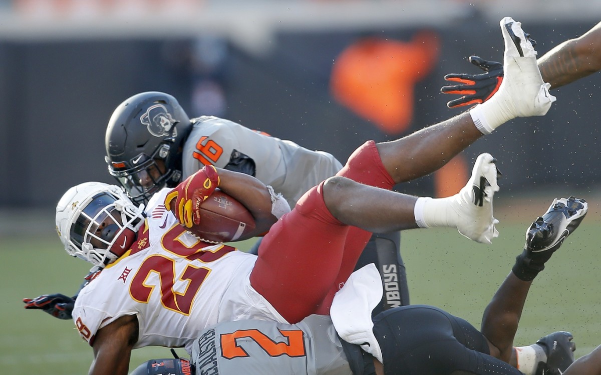 Linebacker Devin Harper (16) and safety Tanner McCalister (2) team up to stop Breece Hall in the win over Iowa State.