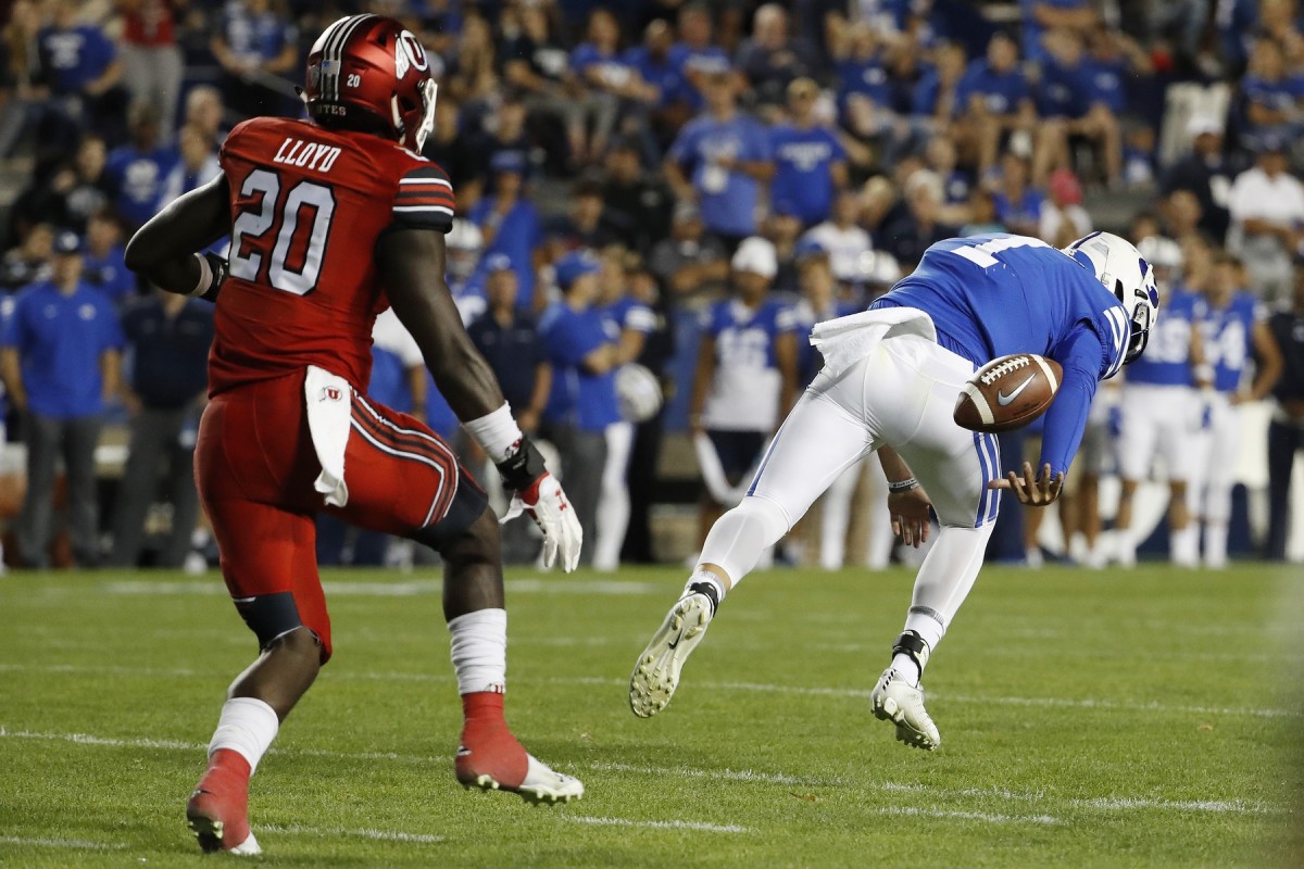 Aug 29, 2019; Provo, UT, USA; Brigham Young Cougars quarterback Zach Wilson (1) fumbles the snap on a two-point conversion attempt against Utah Utes linebacker Devin Lloyd (20) in the fourth quarter at LaVell Edwards Stadium.