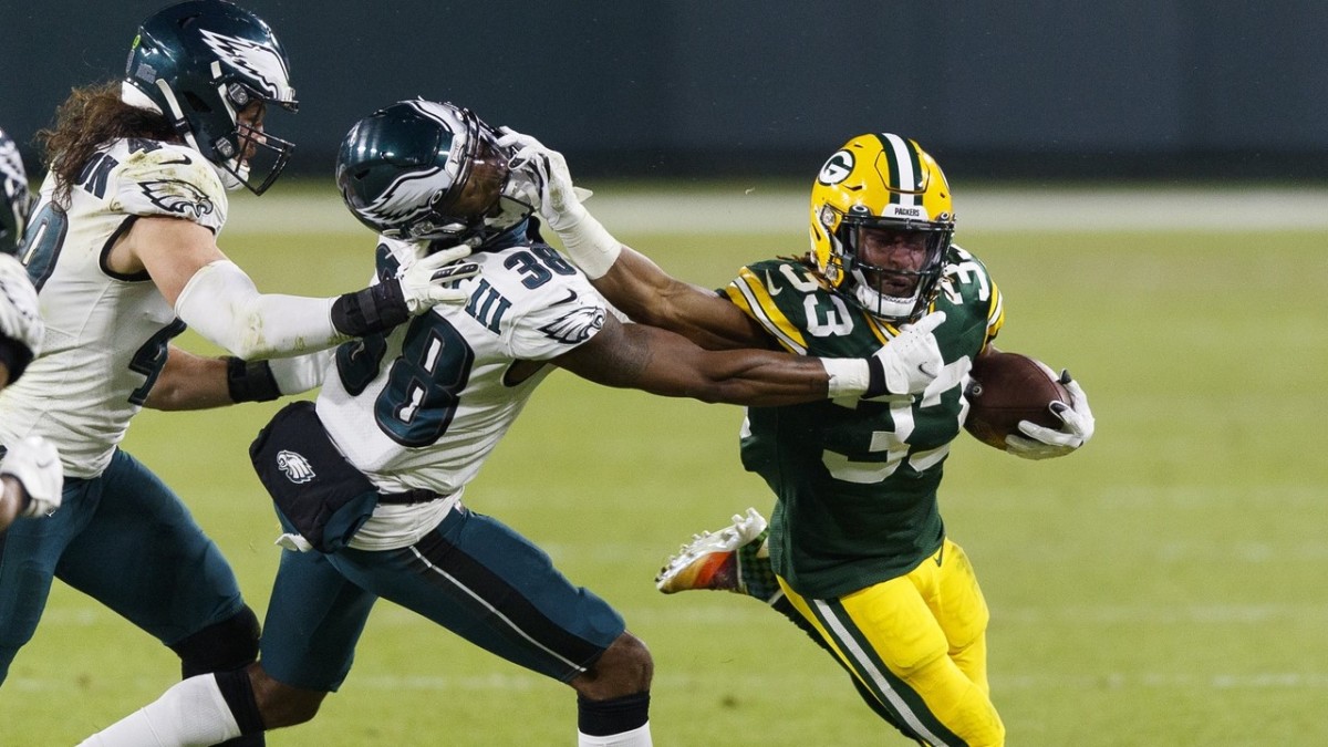 Jones stiff arms Philadelphia Eagles defensive back Michael Jacquet.