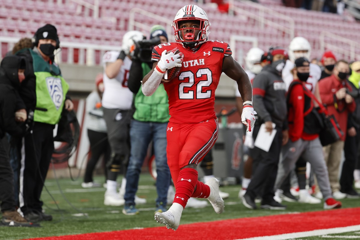 Dec 19, 2020; Salt Lake City, Utah, USA; Utah Utes running back Ty Jordan (22) runs in for a touchdown in the fourth quarter against the Washington State Cougars at Rice-Eccles Stadium.
