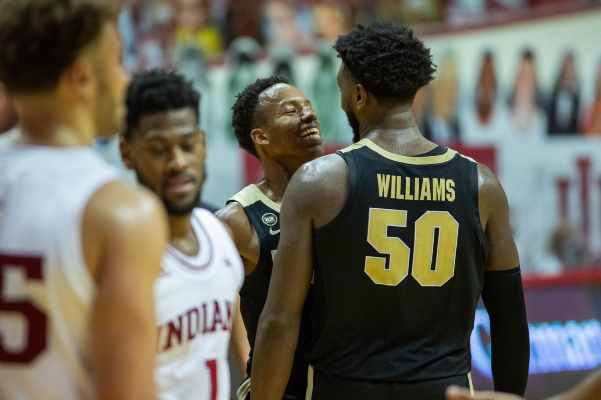 SMILES & FROWNS: Purdue's Eric Hunter Jr. and Trevion Williams celebrate a basket while Indiana's Al Durham drops his head. (USA TODAY Sports)