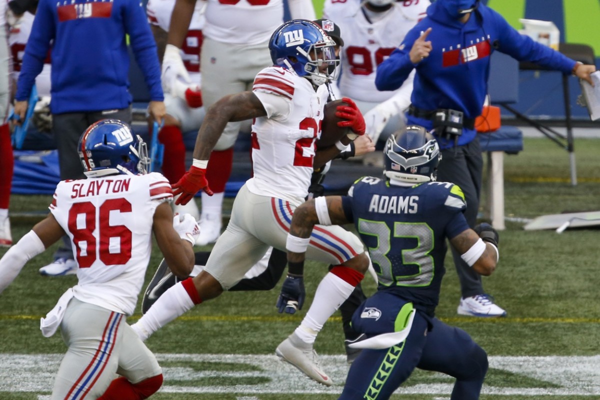 Dec 6, 2020; Seattle, Washington, USA; New York Giants running back Wayne Gallman (22) rushes against the Seattle Seahawks during the third quarter at Lumen Field.
