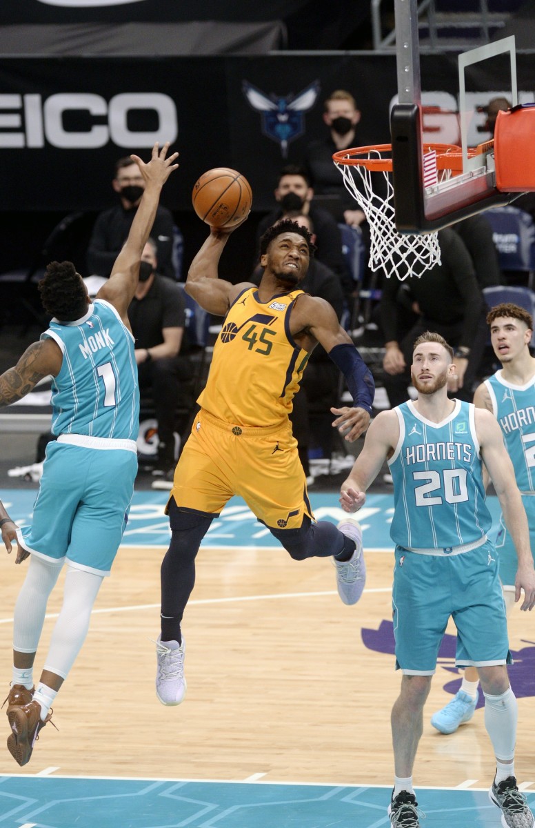 Donovan Mitchell (45) throws it down over Malik Monk (1), Gordon Hayward (20), and LaMelo Ball (2)
