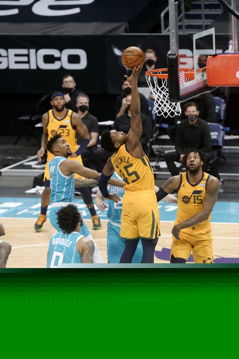 Donovan Mitchell (45) scores a layup against the Charlotte Hornets