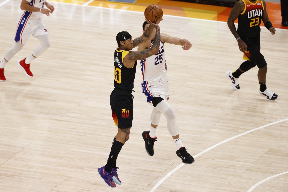 Ben Simmons (25) fouls Jordan Clarkson (00) as Clarkson shoots a 3-pointer