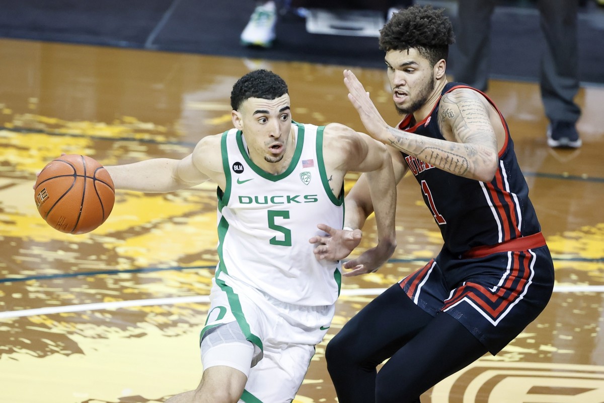 Feb 20, 2021; Eugene, Oregon, USA; Oregon Ducks guard Chris Duarte (5) drives to the basket as Utah Utes forward Timmy Allen (1) defends during the second half at Matthew Knight Arena.