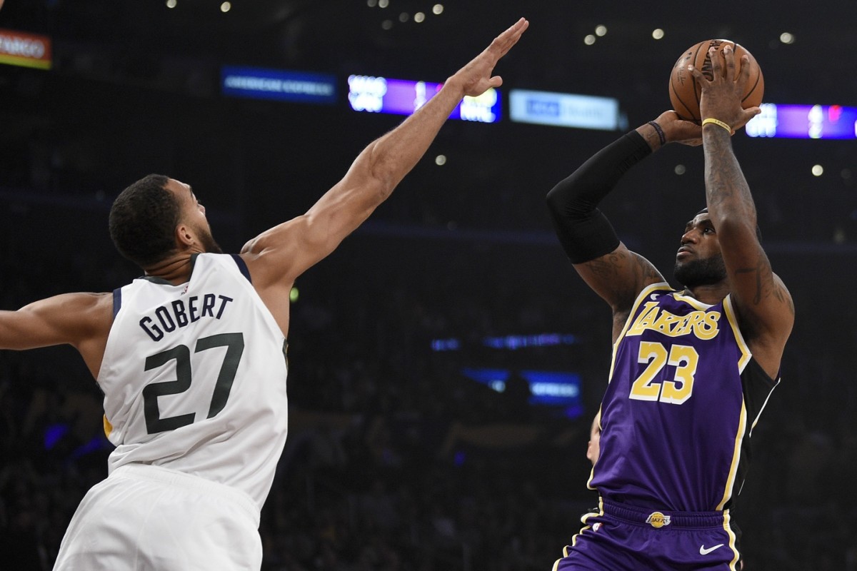 Rudy Gobert (27) contests a shot by LeBron James (23)