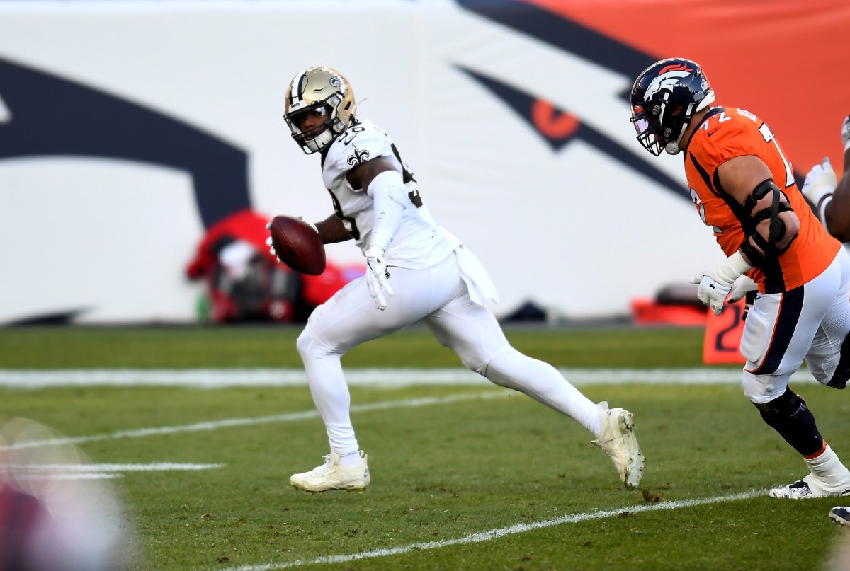 Nov 29, 2020; Denver, Colorado, USA; Saints linebacker Kwon Alexander (58) returns a fumble against Denver Broncos tackle Garett Bolles (72) at Empower Field at Mile High. Mandatory Credit: Ron Chenoy-USA TODAY Sports