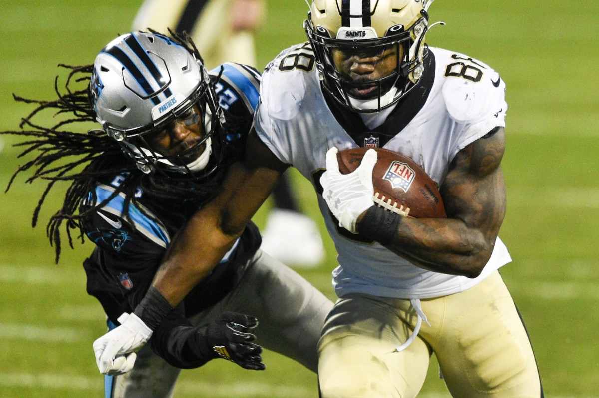 Jan 3, 2021; Charlotte, North Carolina, USA; Saints running back Ty Montgomery (88) with the ball as Carolina cornerback Donte Jackson (26). Mandatory Credit: Bob Donnan-USA TODAY Sports
