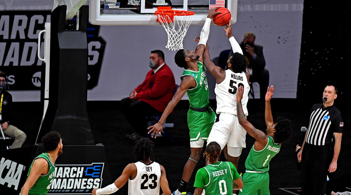 Thomas Bell blocks a shot by Trevion Williams.
